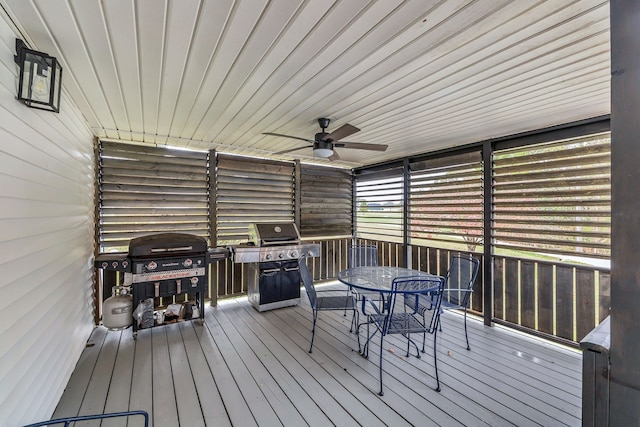 wooden deck featuring ceiling fan and a grill