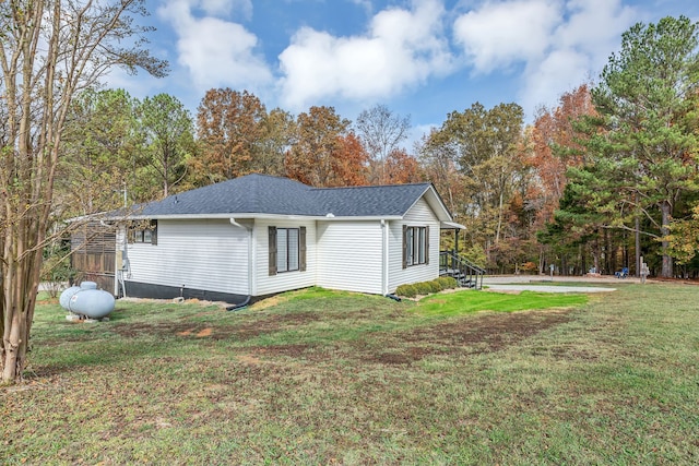 view of side of home with a lawn