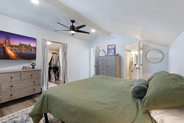 bedroom featuring wood-type flooring, vaulted ceiling with beams, connected bathroom, ceiling fan, and a spacious closet