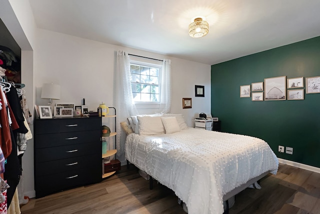 bedroom with dark hardwood / wood-style floors