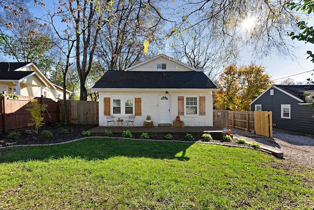 bungalow-style home featuring a front yard and a patio area