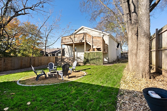 view of yard with an outdoor fire pit and a deck