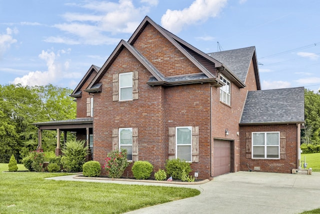 view of front of home with a front lawn and a garage