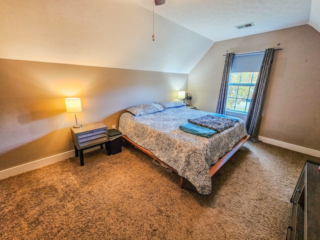 bedroom featuring ceiling fan, lofted ceiling, a textured ceiling, and dark carpet