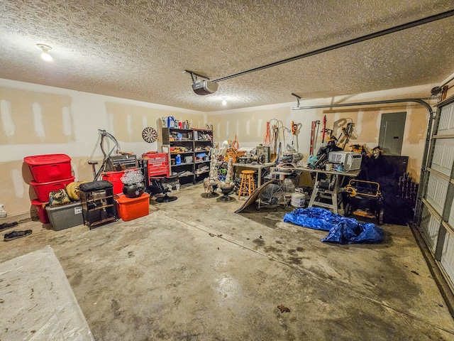 garage with a garage door opener and electric panel