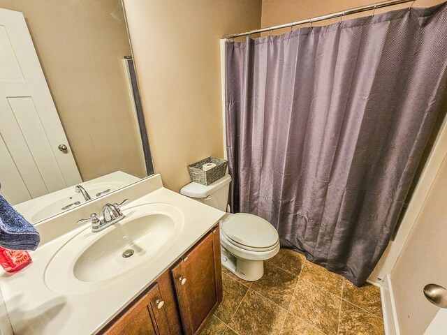 bathroom featuring a shower with curtain, vanity, and toilet