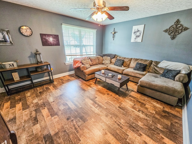 living room featuring a textured ceiling, hardwood / wood-style flooring, and ceiling fan