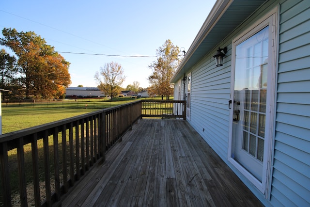 wooden deck featuring a lawn