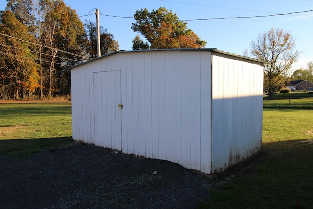 view of outbuilding with a lawn