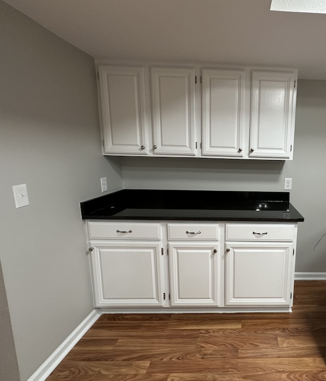 kitchen featuring dark hardwood / wood-style floors and white cabinets