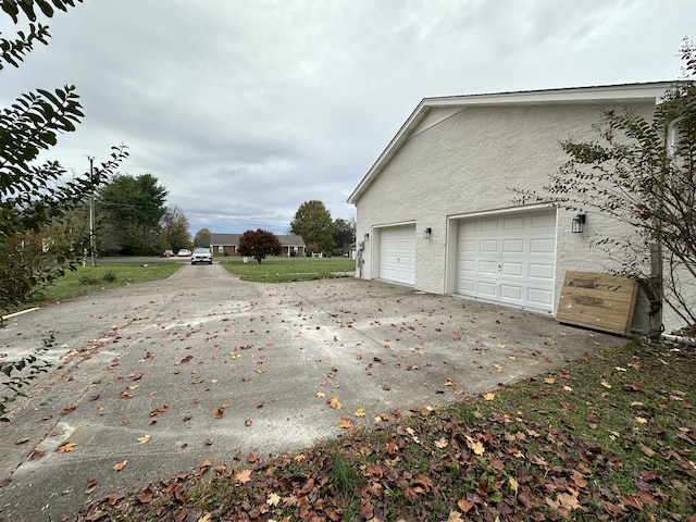 view of side of home featuring a garage