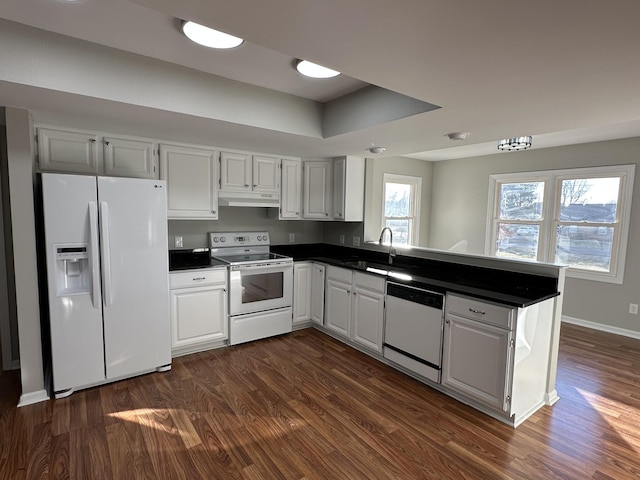 kitchen featuring white cabinetry, sink, and white appliances