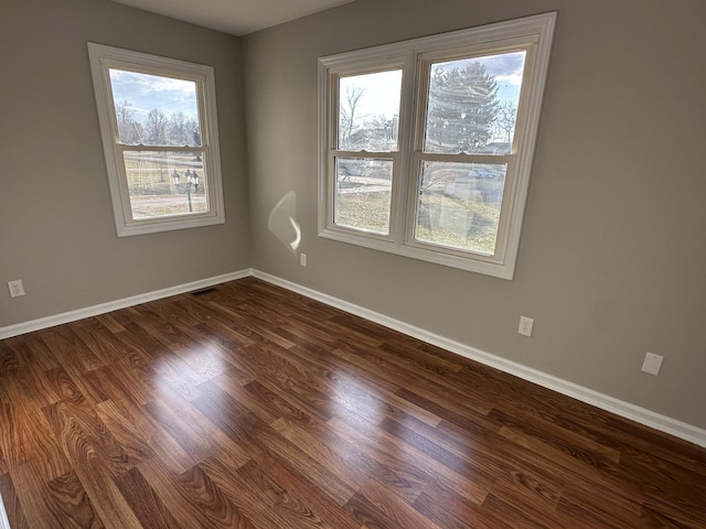 unfurnished room featuring dark wood-type flooring