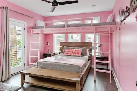 bedroom featuring access to outside, ceiling fan, multiple windows, and wood-type flooring