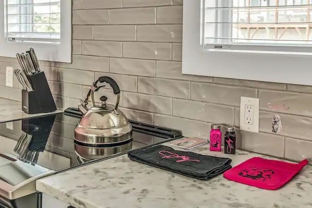 details with decorative backsplash and light stone counters