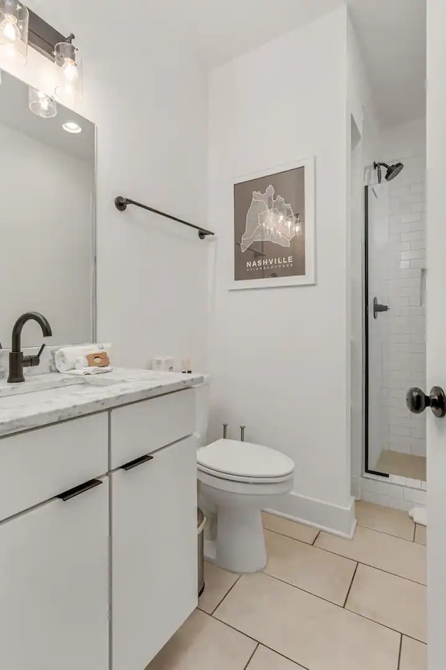 bathroom with tile patterned flooring, vanity, toilet, and a shower with shower door