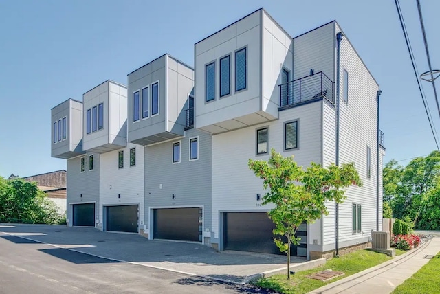 view of side of property with a balcony and a garage