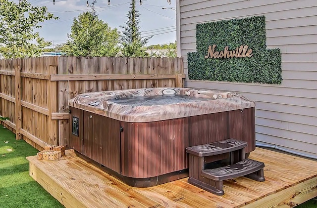 wooden deck with a hot tub