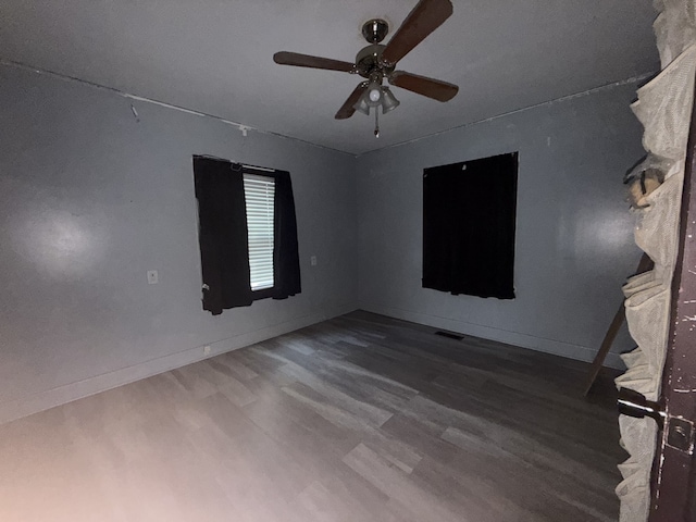 empty room with wood-type flooring and ceiling fan