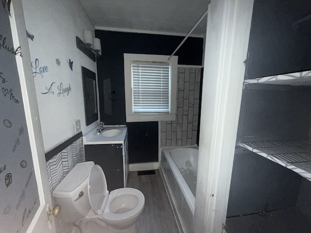 full bathroom featuring toilet, tiled shower / bath combo, and vanity