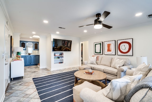 living room featuring ceiling fan and ornamental molding