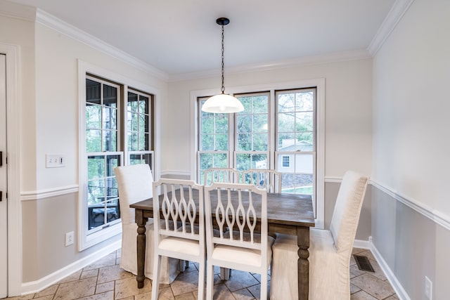 dining room featuring crown molding