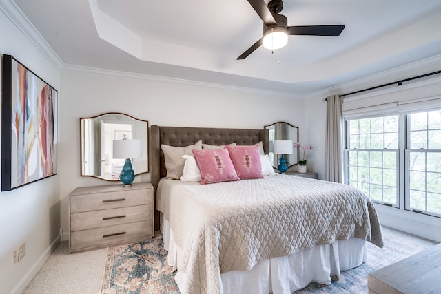 bedroom featuring a tray ceiling, ceiling fan, light carpet, and ornamental molding