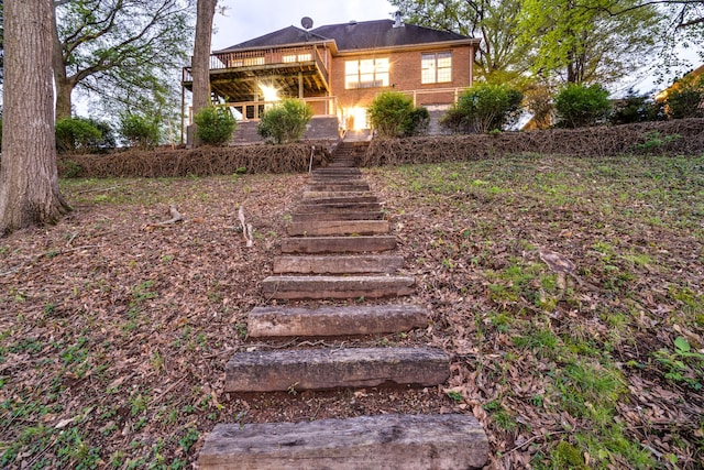 rear view of property featuring a wooden deck