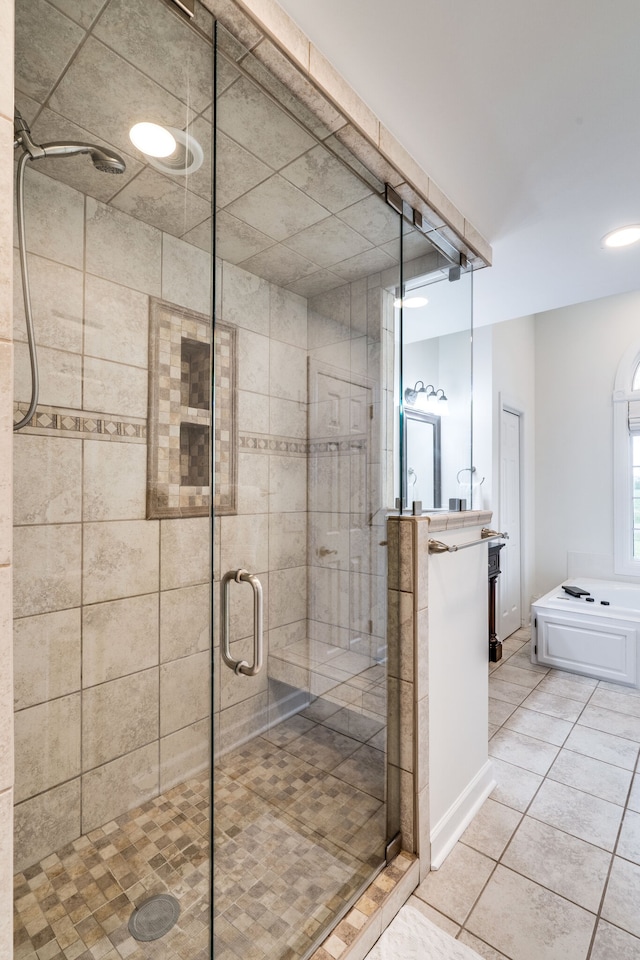 bathroom with a shower with door and tile patterned floors