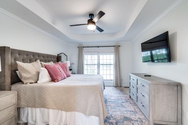 bedroom with ceiling fan, a raised ceiling, and crown molding