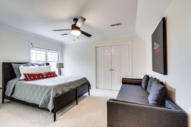 bedroom with light carpet, ceiling fan, crown molding, and a closet