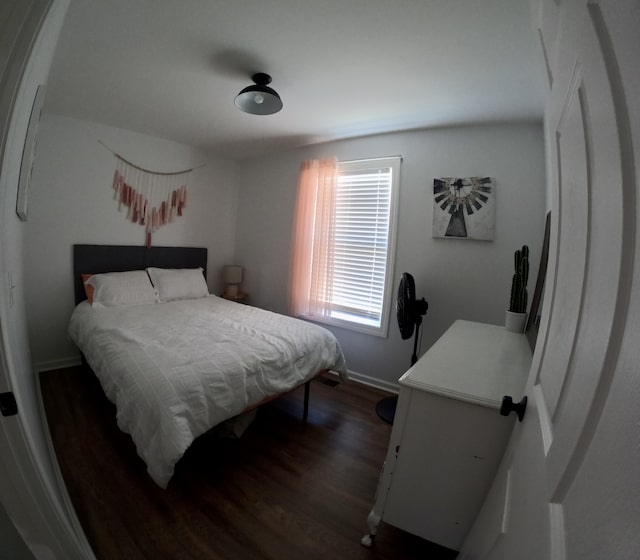 bedroom with dark wood-type flooring