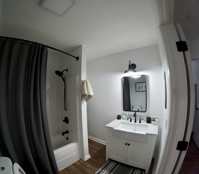 bathroom with shower / bath combo, wood-type flooring, and vanity