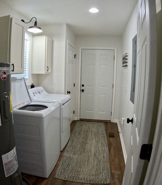 laundry area featuring electric water heater, dark hardwood / wood-style flooring, cabinets, and independent washer and dryer