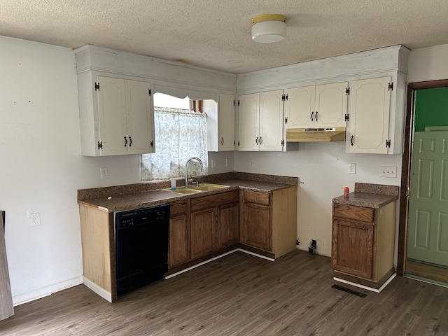 kitchen with dishwasher, dark wood-type flooring, sink, and a textured ceiling