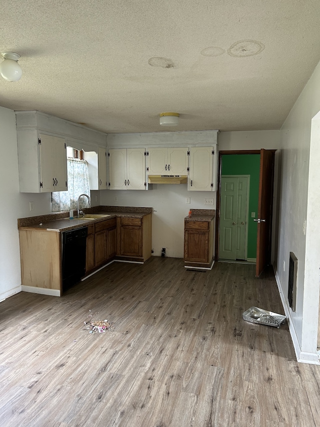 kitchen with sink, a textured ceiling, light hardwood / wood-style flooring, white cabinets, and dishwasher