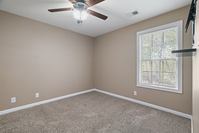 carpeted empty room featuring ceiling fan