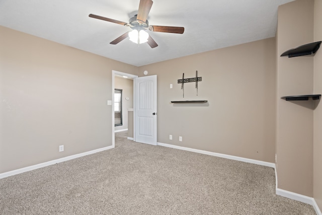 spare room featuring carpet and ceiling fan