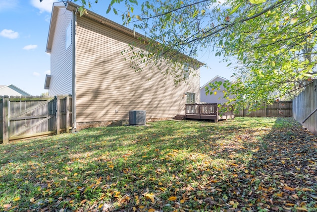 back of house with a yard, central AC unit, and a deck