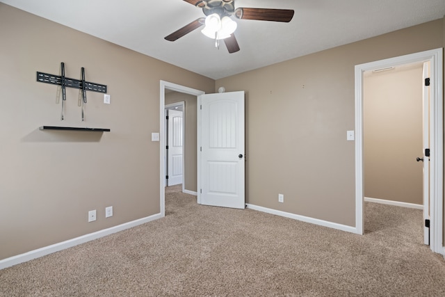 unfurnished bedroom featuring light carpet and ceiling fan