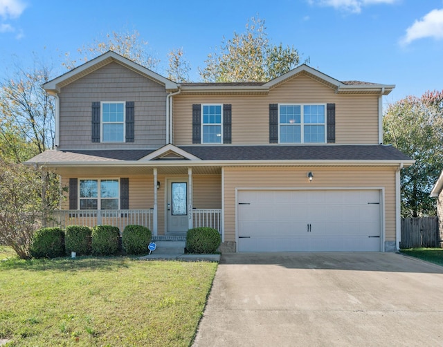 view of front of home featuring covered porch, a garage, and a front lawn