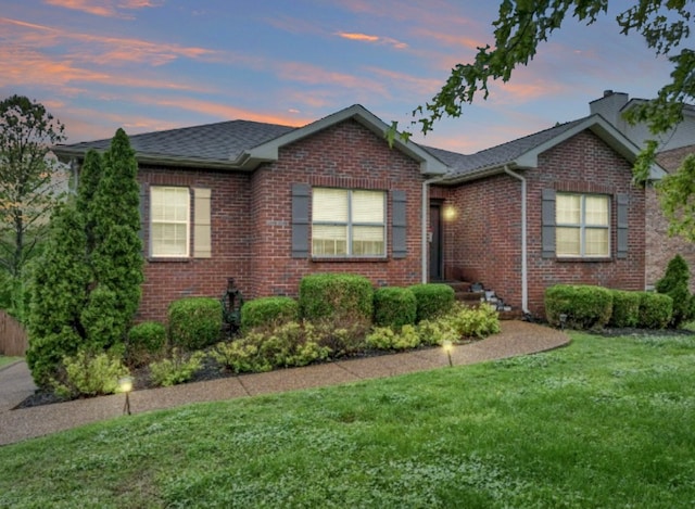 ranch-style house with a lawn