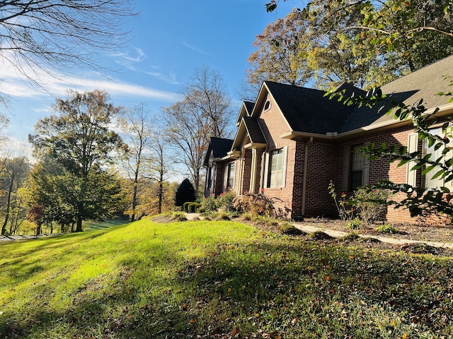 view of home's exterior with a yard