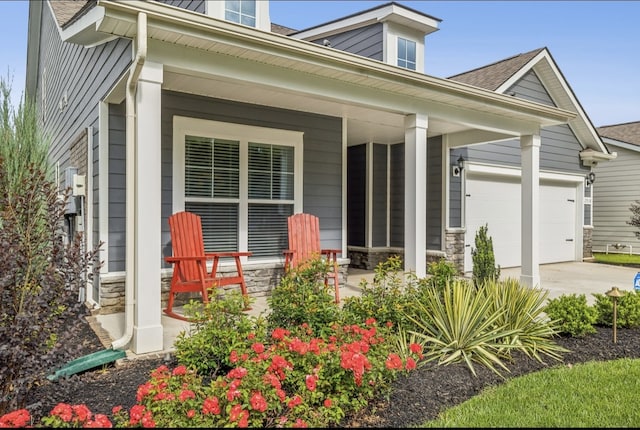 exterior space featuring a garage and covered porch