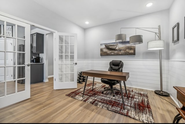 office area featuring french doors, hardwood / wood-style floors, and lofted ceiling