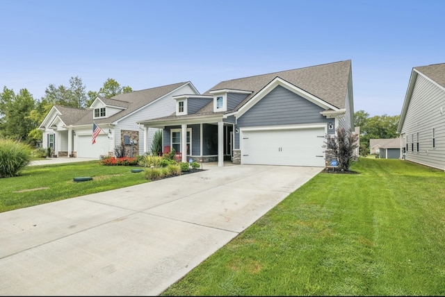 view of front facade featuring a front yard, covered porch, and a garage