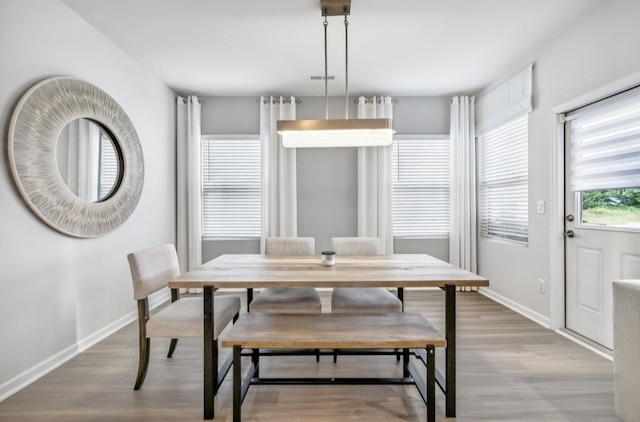 dining space featuring hardwood / wood-style floors