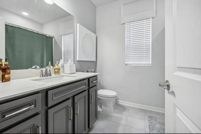 bathroom featuring tile patterned flooring, vanity, and toilet