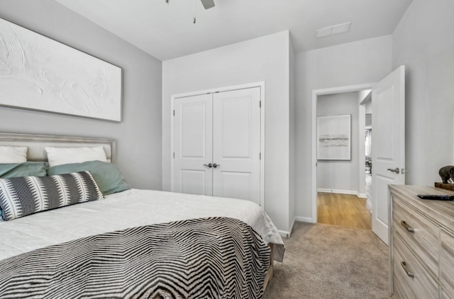 bedroom with a closet, light carpet, and ceiling fan