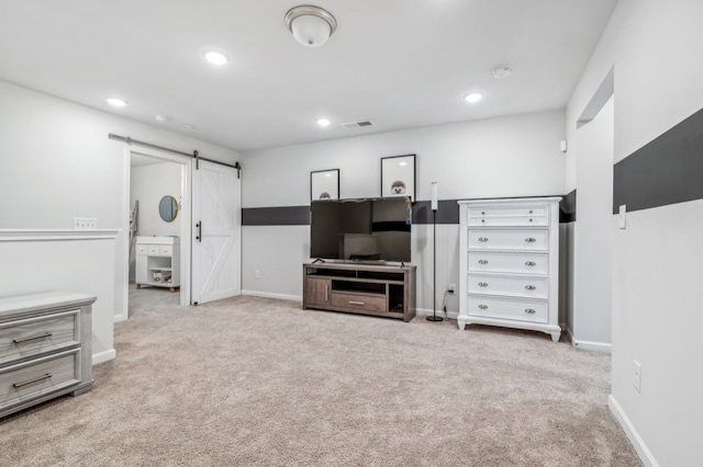 carpeted living room featuring a barn door